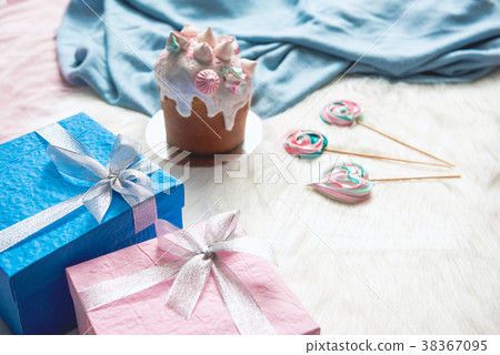 Cake with presents and sweets situating on rug Cake with presents and sweets situating on rug 38367095