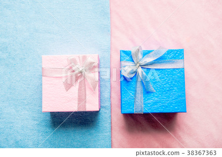 Blue and pink gifts locating on rug 38367363