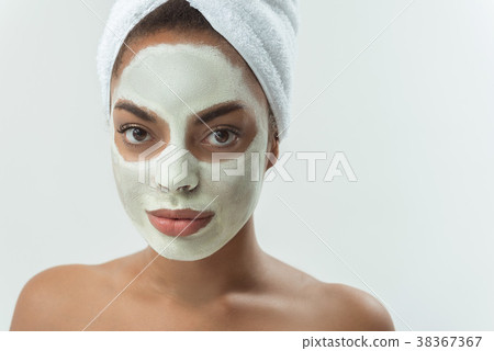 Calm female with caring of her skin Calm female with caring of her skin 38367367