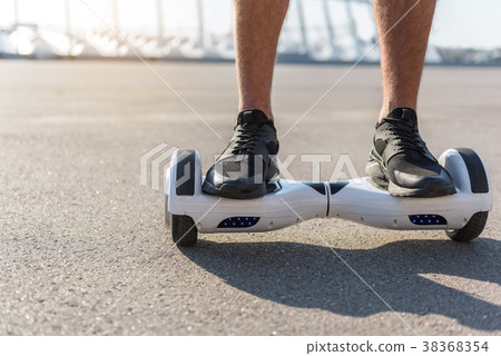 Man legs riding on gyroscope outdoor 38368354
