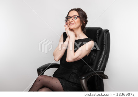 Picture of beautiful woman in black dress sitting Picture of beautiful woman in black dress sitting 38369072