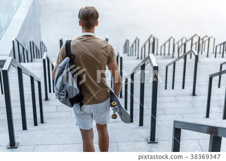 Teenager keeping board in arm 38369347