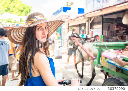Woman goes shopping by bike in touristic center 38370090