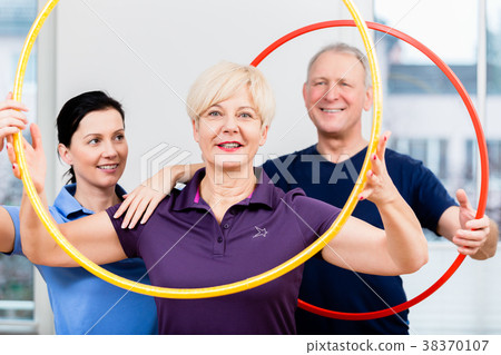Senior couple in physiotherapy doing exercise with Senior couple in physiotherapy doing exercise with 38370107