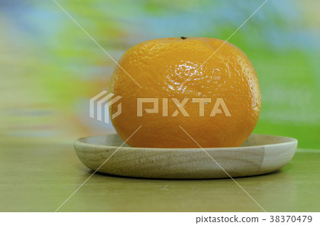 Orange in a wooden tray with a blurred background. Orange in a wooden tray with a blurred background. 38370479