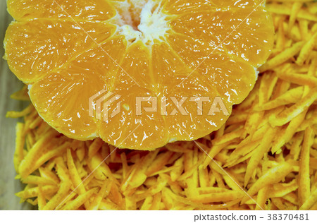 Half a torn orange with sliced orange skin. Half a torn orange with sliced orange skin. 38370481