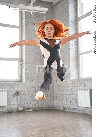 Young sport woman gymnastics doing jumping Young sport woman gymnastics doing jumping 38370616