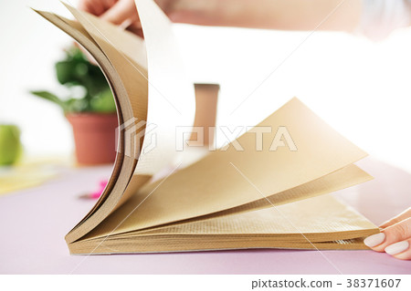 The business woman in the workplace flips through The business woman in the workplace flips through 38371607