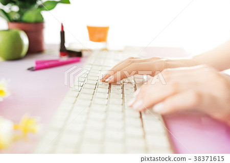 Woman and fruit diet while working on computer in Woman and fruit diet while working on computer in 38371615