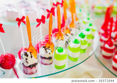 Delicious and tasty dessert table with cupcakes 38371844