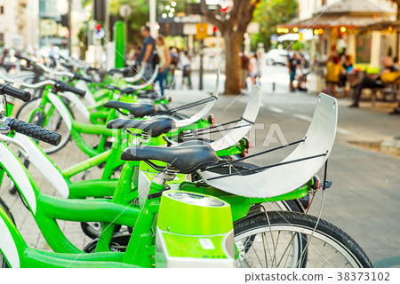 Row of public bicycle on rental station on city Row of public bicycle on rental station on city 38373102