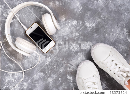 Flat lay Of White Sneakers On stone Background 38373824