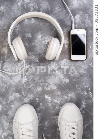 Flat lay Of White Sneakers On stone Background 38373831