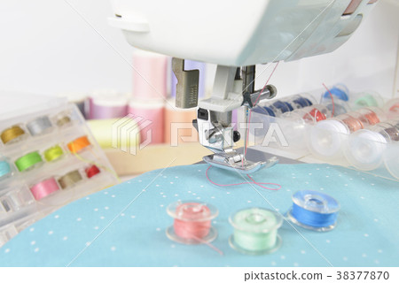 Sewing machine and colorful thread rolls. Sewing machine and colorful thread rolls. 38377870