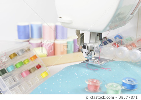Sewing machine and colorful thread rolls. 38377871
