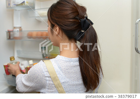 Housewife taking ingredients from the refrigerator 38379017