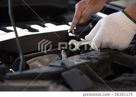 Mechanic repairing a car  in garage  Auto repair  38381175