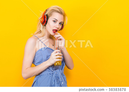 Blonde girl in blue striped blouse with headphones 38383878
