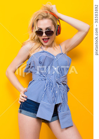 Girl in blouse with headphones and sunglasses 38383892