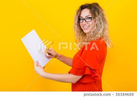 Woman in dress with blank paper and pencil Woman in dress with blank paper and pencil 38384689