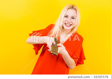 Blonde woman in dress with remote control 38385576