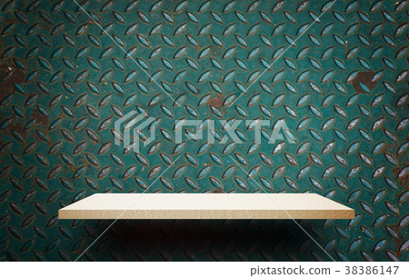 Empty wooden shelf display on metal wall sheet 38386147