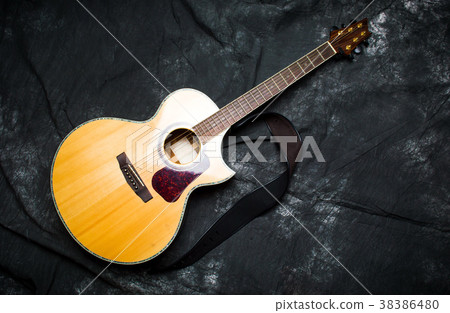 Acoustic guitar in a case on dark background Acoustic guitar in a case on dark background 38386480