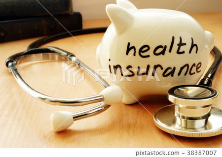 Piggy bank with words on a side health insurance. 38387007
