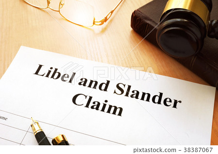 Libel and Slander Claims on a desk. 38387067