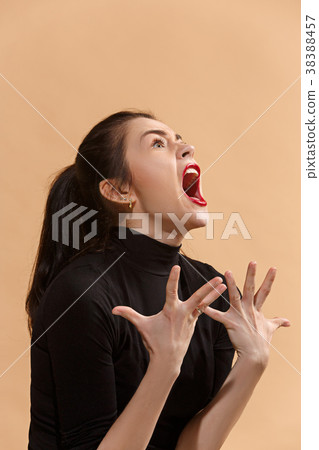 The young emotional angry woman screaming on The young emotional angry woman screaming on 38388457