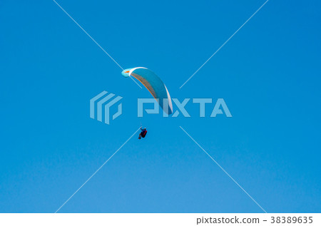 Paraglider flying in the sky 38389635