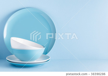 Crockery and cutlery on a blue pastel background 38390286