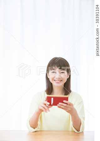 Young woman woman portrait smiling using a smartphone White house Fashionable house Woman with white background 38391104