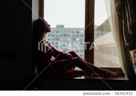 beautiful sexy girl in a red robe is sitting on beautiful sexy girl in a red robe is sitting on 38391452