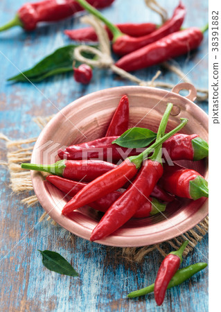 Chili peppers in a copper pot 38391882