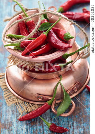 Chili peppers in a copper pot 38391883