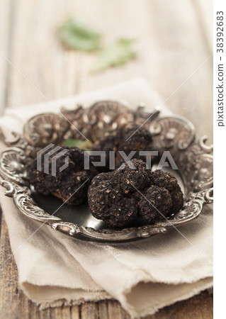 Black truffles on plate. 38392683