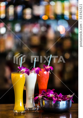 Vertical still life 3 cocktails and orchid flowers 38392821