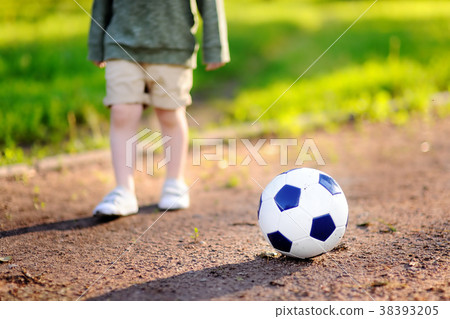 boy having fun playing a soccer/football game boy having fun playing a soccer/football game 38393205