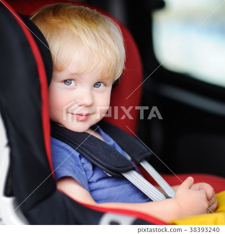 Portrait of pretty toddler boy sitting in car seat Portrait of pretty toddler boy sitting in car seat 38393240