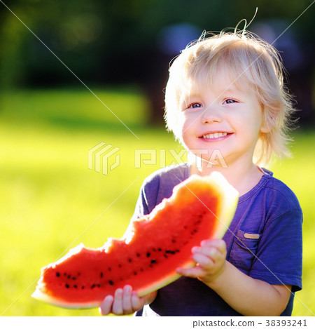 Little boy eating fresh watermelon outdoors Little boy eating fresh watermelon outdoors 38393241