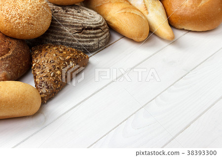 assorted of bread on white wooden background. assorted of bread on white wooden background. 38393300