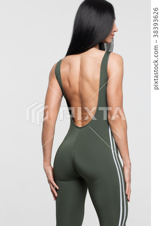 Slim tanned woman body over gray background Slim tanned woman body over gray background 38393626