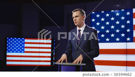 Presenter in front of American flag Presenter in front of American flag 38394662