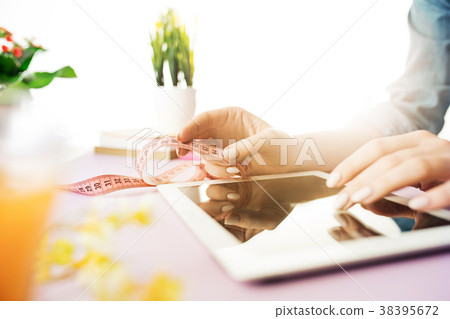 Woman and fruit diet while working on computer in 38395672