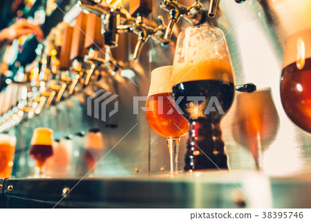 Hand of bartender pouring a large lager beer in Hand of bartender pouring a large lager beer in 38395746