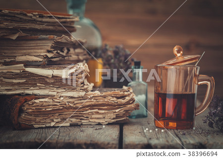 Old books, tincture in glass, homeopathic bottle. Old books, tincture in glass, homeopathic bottle. 38396694