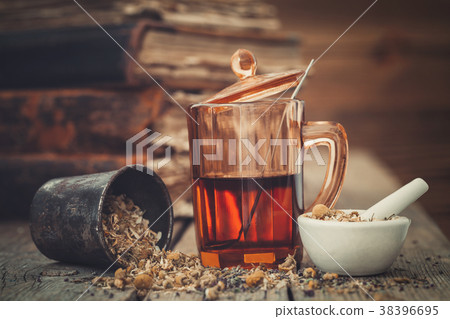 Healthy tea in glass, mortars of herbs. 38396695