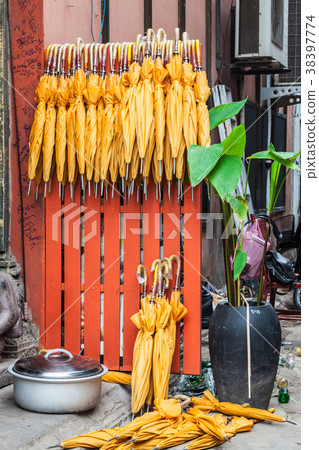 Stack of yellow umbrellas for sale at a stall Stack of yellow umbrellas for sale at a stall 38397774