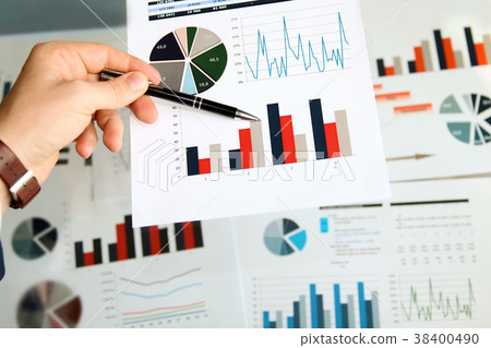 Business man working and analyzing graphs Business man working and analyzing graphs 38400490